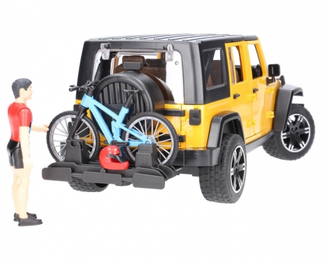 Bruder Jeep Wrangler Rubicon s cyklistou a kolem